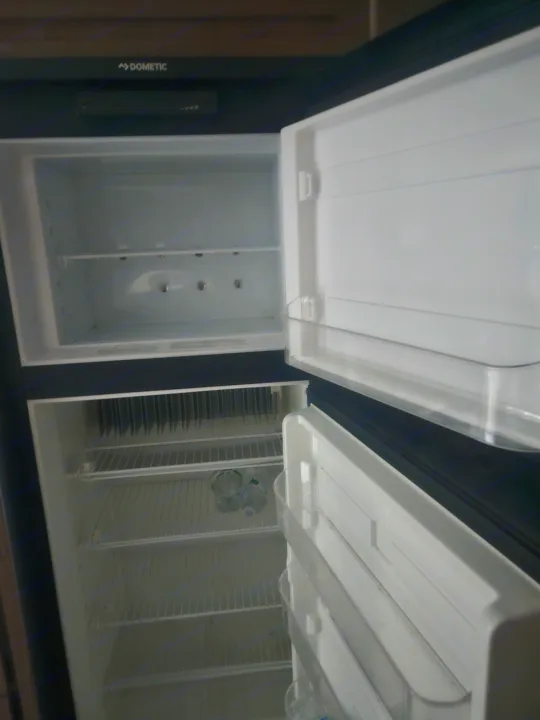 Empty Dometic refrigerator in an RV rental, ready for your groceries.. Imagine Imagine design 2020
