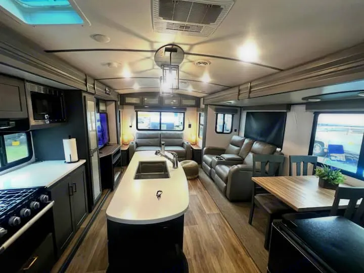 Spacious, modern RV rental interior with full kitchen, dining area, and comfortable living space for your adventures.. Keystone RV Bullet Premier Ultra Lite 2022