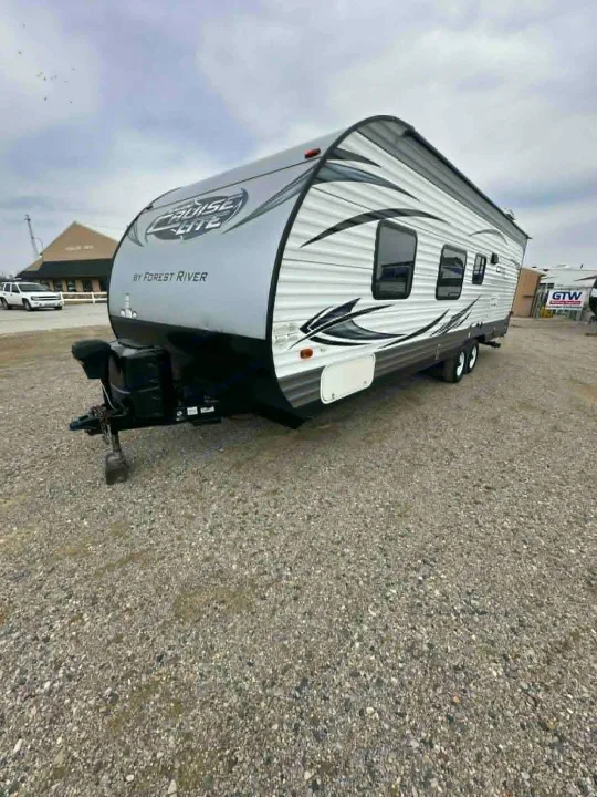 Gray and white Forest River Cruise Lite travel trailer parked on a gravel lot, ready for your rv rental.. Forest River Salem Cruise Lite 2016