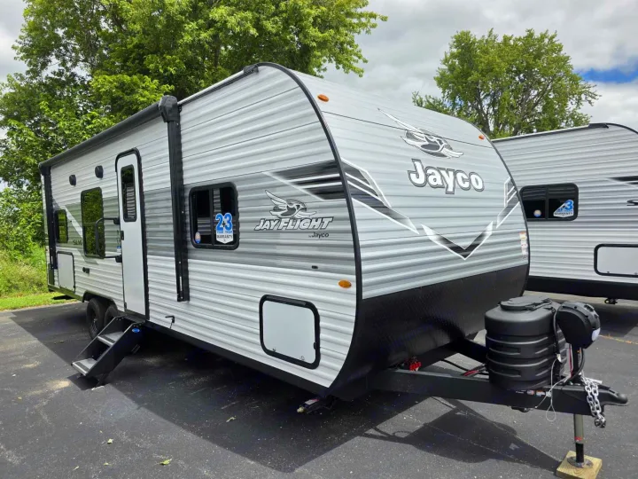 This Jayco Jay Flight travel trailer, ideal for an RV rental, features a light gray exterior and deployed steps.. Jayco Jay Flight 2026