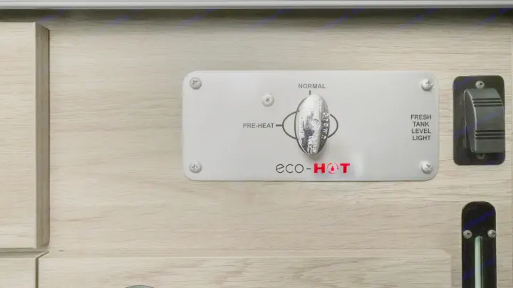 RV rental: eco-HOT water heater control panel, showing Pre-heat, Normal modes, and a Fresh Tank Level light.. Winnebago Solis 2024