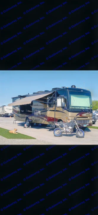 Gold Fleetwood Bounder rv rental: extended awning, motorcycle, and dog on turf. Perfect for your next adventure!. Fleetwood Bounder 2013