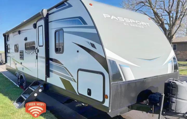 Explore in this modern Passport SL Series RV rental. Its sleek design and a "FREE WIFI" graphic promise adventure.. Keystone RV Passport SL 2021