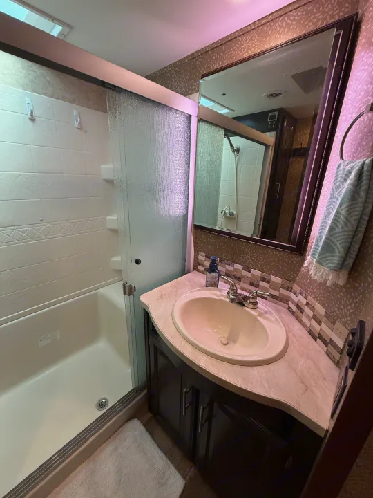 Experience comfort in this RV rental bathroom, complete with a shower, vanity, sink, and mirror, designed for compact living.. Jayco Eagle 2017