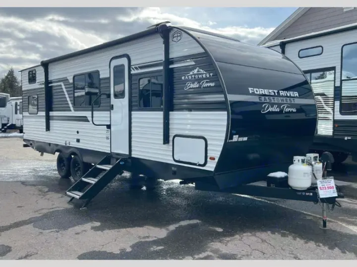 Discover the outdoors! This Forest River Della Terra travel trailer, with its black and white design and steps, is ready for your rv rental camping trip.. Della Terra 250QB 2026