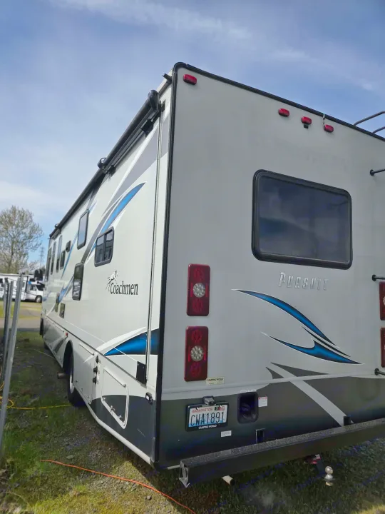 A gray Coachmen Pursuit RV rental, featuring blue graphics and a Washington license plate, is ready for your next camping adventure.. Forest River Coachmen Pursuit 2022
