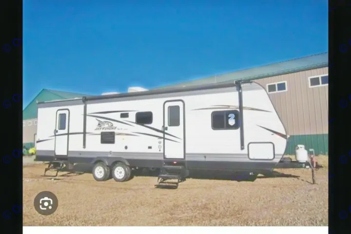 White Jay Flight SLX travel trailer, perfect for your next rv rental adventure. Parked on gravel, ready for the road.. Jayco Jay Flight SLX 2018