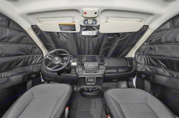 Front cab of an RV rental showing custom black quilted insulation panels covering the windshield and side windows for privacy.. Winnebago Solis 2025