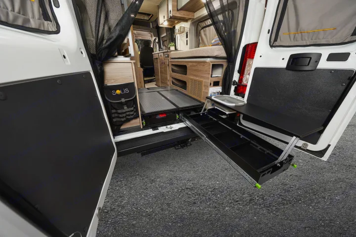 RV rental: Rear of camper van reveals pull-out gear tray & door-mounted sink/counter for outdoor utility.. Winnebago Solis 2025