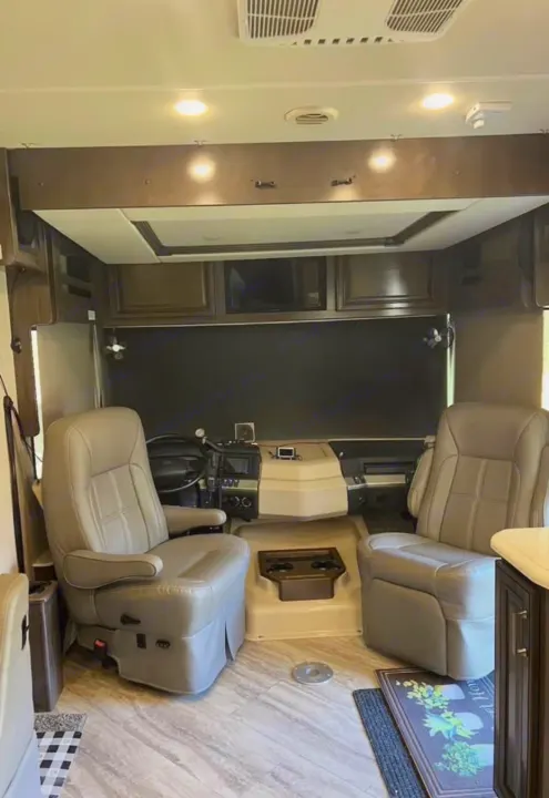 Spacious RV rental cockpit with tan captain's chairs, a modern dashboard, and wood-look flooring.. Southwind Southwind Motorhome 2020