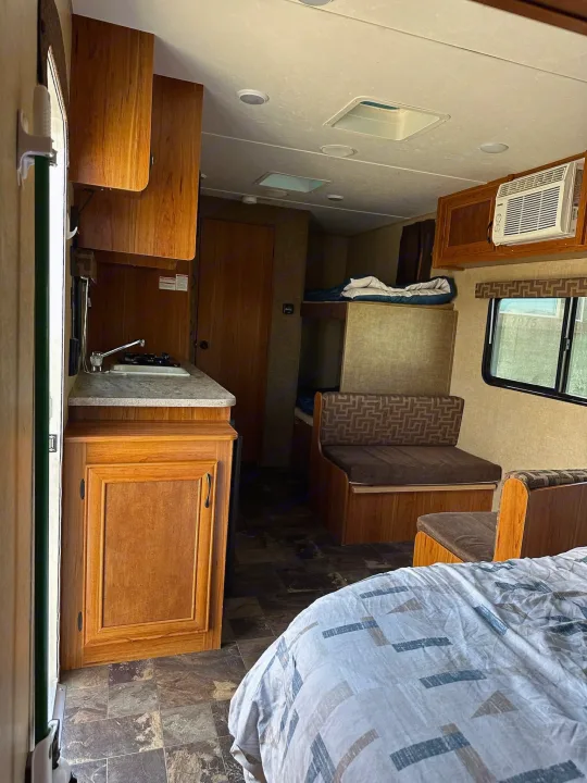 RV rental: Interior view featuring kitchen with sink, bunk beds, dinette seating, main bed area, and wood cabinets.. Starcraft AR-One Maxx 2017