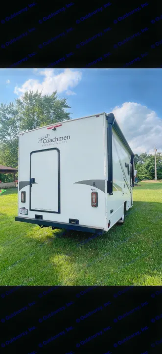 Rear view of a white Coachmen Freelander RV rental on grass. Clear skies above a parked camper for your adventure.. Coachmen Freelander 22xg 2020