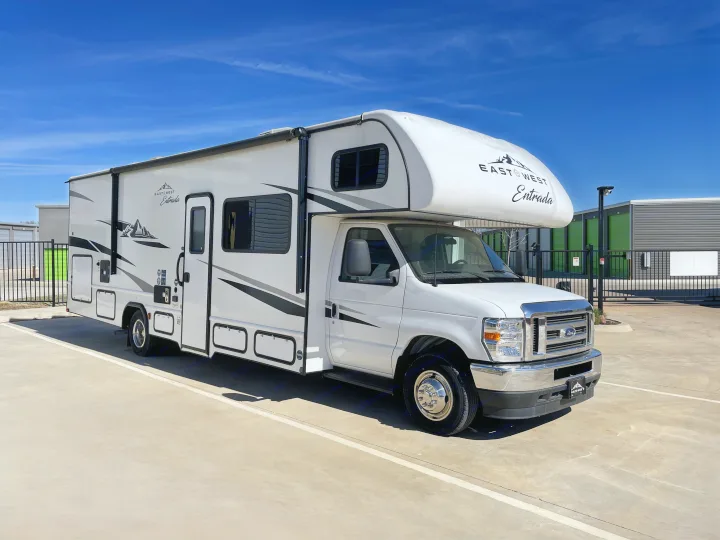 White East to West Entrada rv rental parked on a concrete lot, ready for your next adventure.. East to West Entrada 2024