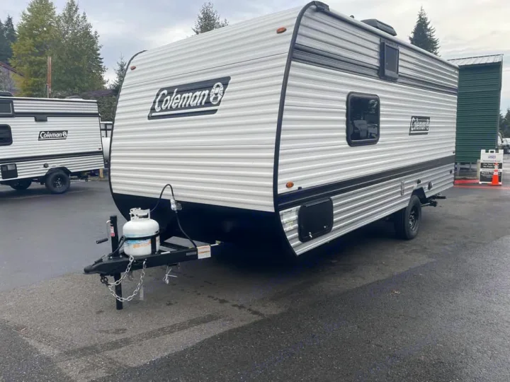 A modern Coleman travel trailer, equipped with a propane tank, ideal for your next rv rental or outdoor camping adventure.. Keystone RV Coleman 2025