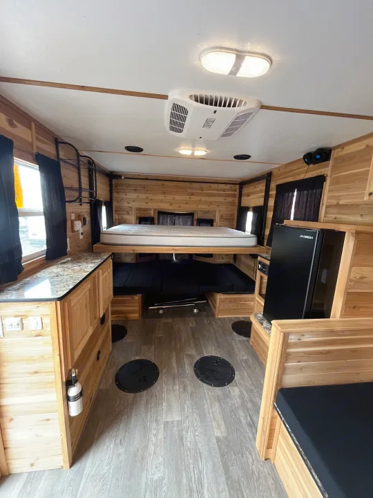 Cozy rv rental: wood-paneled ice fishing house with elevated bed, kitchen, AC, & floor fishing holes. Perfect adventure!. Ice Castle Fish Houses Ice Castle Fish Houses Trailer 2020