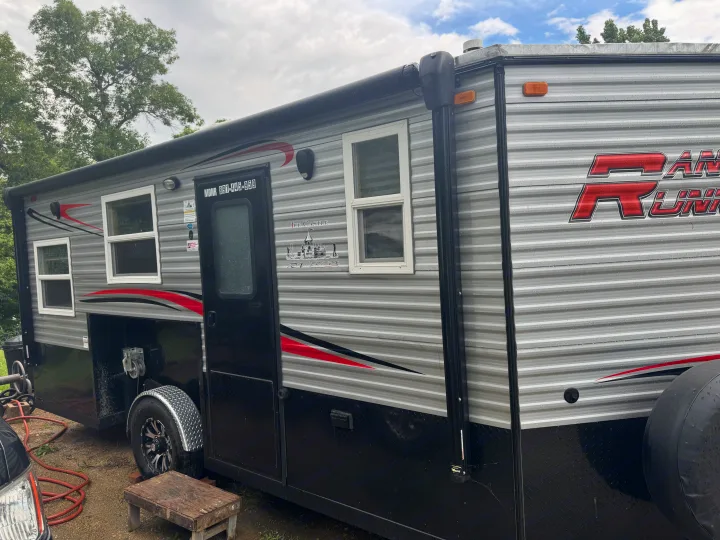 Ice Castle RV rental with red/black accents. This Ram Runner travel trailer is ready for adventure, even with raindrops on its side.. Ice Castle Fish Houses Ice Castle Fish Houses Trailer 2023