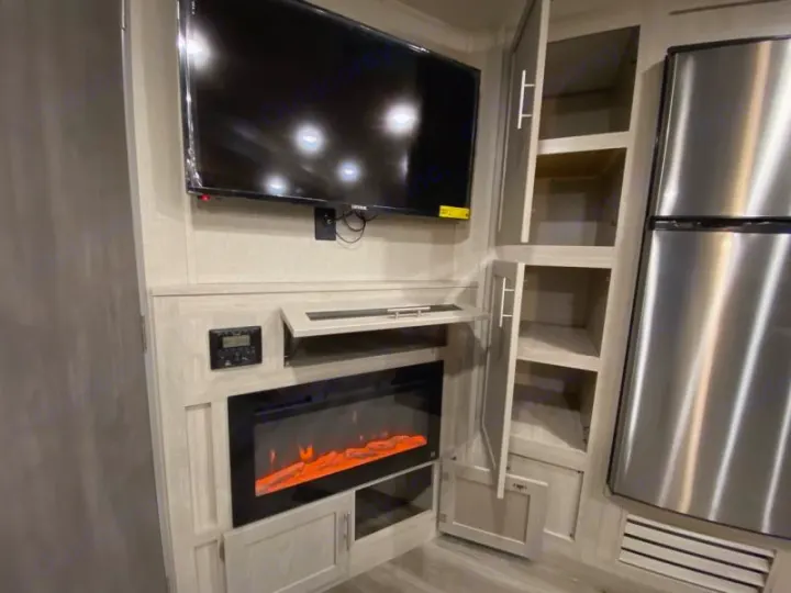 Enjoy this RV rental's modern interior: flat-screen TV, electric fireplace, open storage cabinets, and a stainless steel fridge.. Coachmen catalina 2022