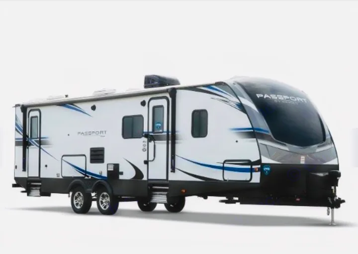 This sleek white travel trailer with blue accents is an ideal RV rental for your next outdoor adventure or camping trip.. Keystone RV Passport GT 2021