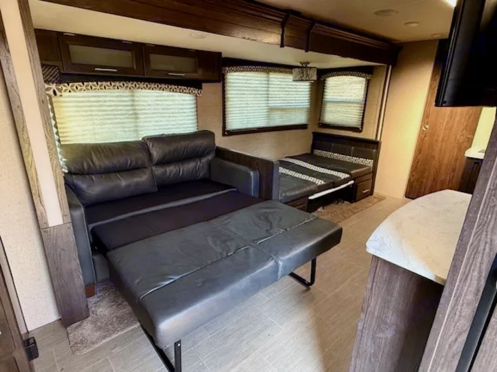 Spacious RV rental interior features a pull-out sofa bed and convertible dinette, ideal for comfortable living and sleeping.. Kodiak Ultimate 288BHSL 2018