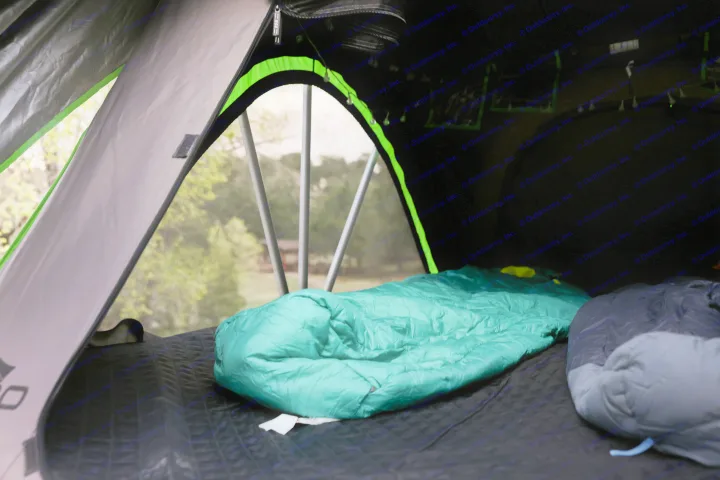 Inside a comfy tent, part of an RV rental setup, featuring sleeping bags and a window view of nature.. No Boundaries 10 2020
