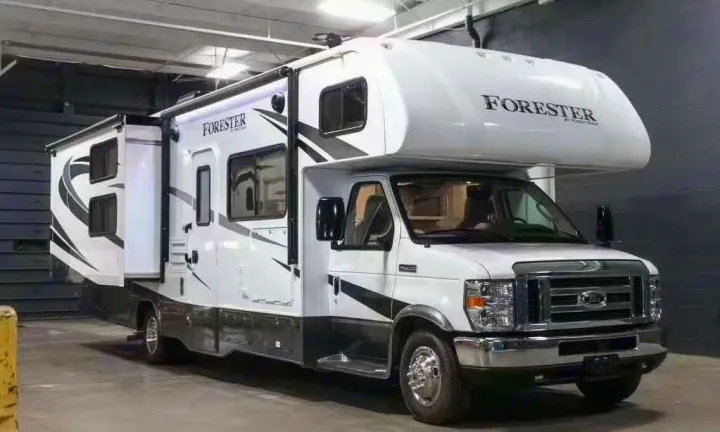 White and gray Forester Class C RV rental, featuring an extended slide-out. Ideal for travel and outdoor adventures.. Forest River forester 2017