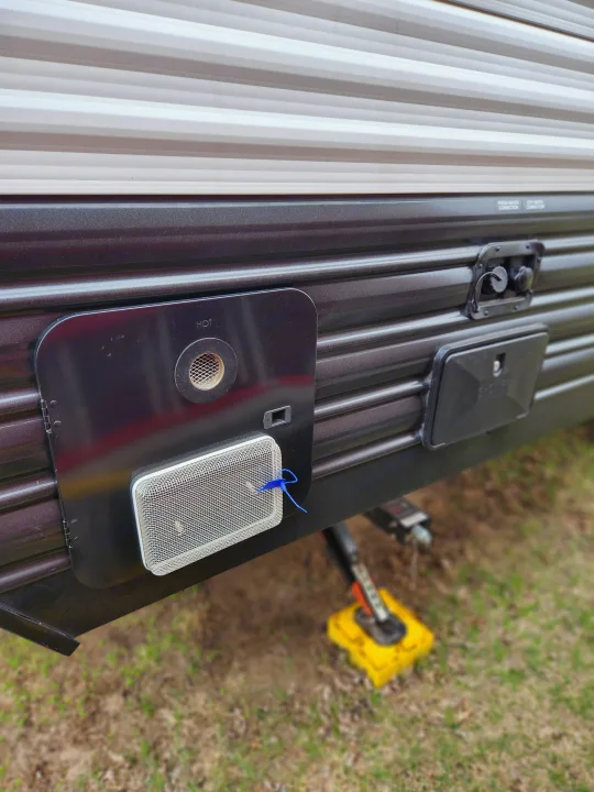 This RV rental's utility panel features a water heater access, outdoor shower, and fresh/city water connections on its side.. Forest River Cherokee Wolf Pup 2024