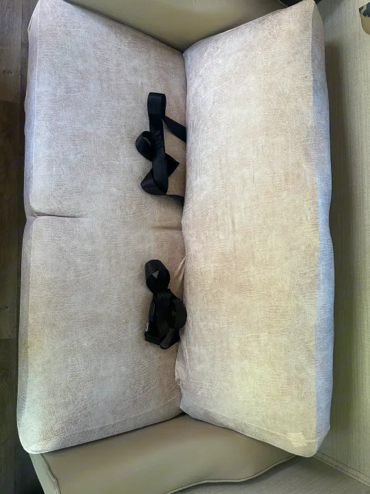 RV rental: Textured light gray seat cushions with black safety belts for secure travel in the RV interior.. Jayco Redhawk 2019