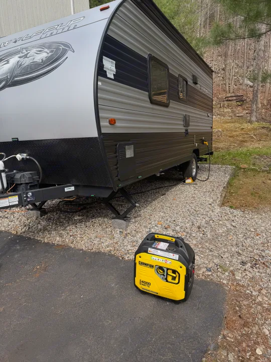 Wolf Pup RV rental with a Champion 4000W generator providing power at a gravel campsite.. Forest River Cherokee Wolf Pup 2021