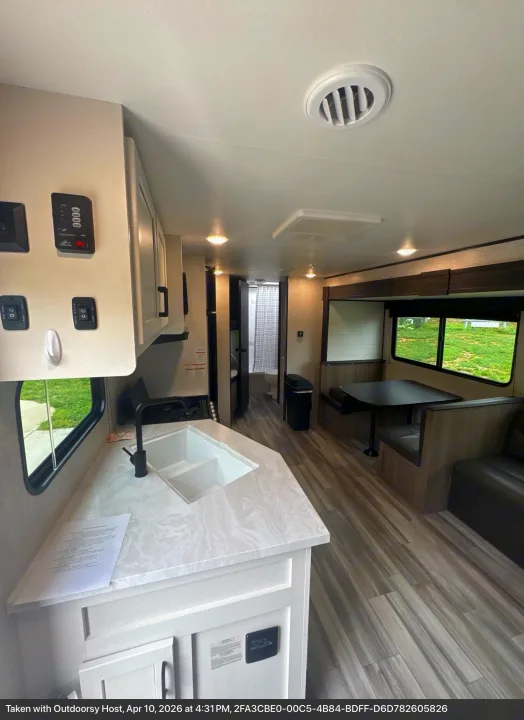 Spacious RV rental interior featuring a modern kitchen with sink, dining area, and comfortable seating, perfect for your next adventure.. Jayco Jay Flight SLX 2024