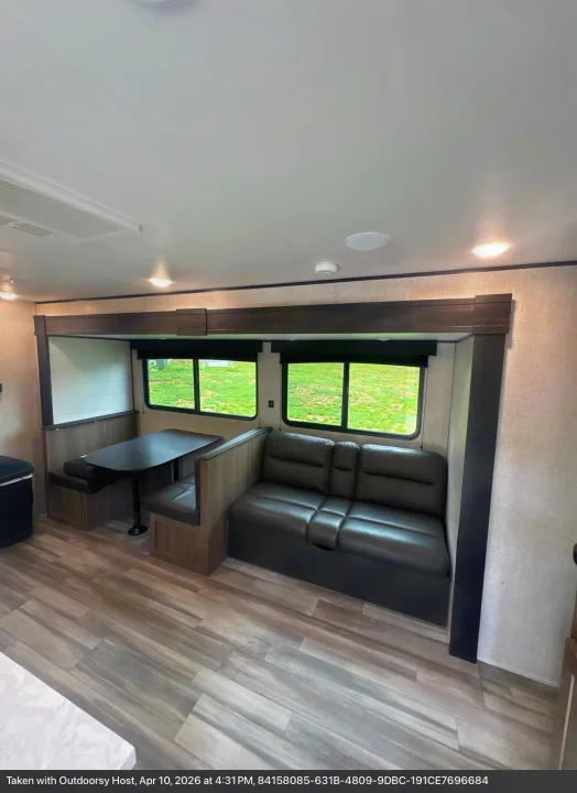 Modern RV rental living area featuring a comfortable dinette and sofa, ideal for your next road trip adventure.. Jayco Jay Flight SLX 2024