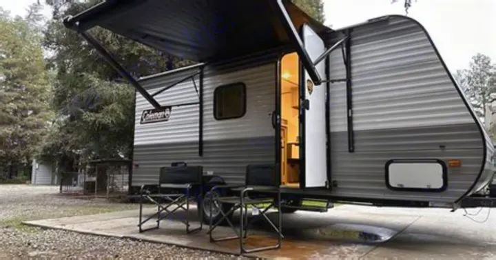 This Coleman rv rental features an extended awning, open door with lit interior, and camp chairs for a relaxing outdoor stay.. Coleman Lantern 2023