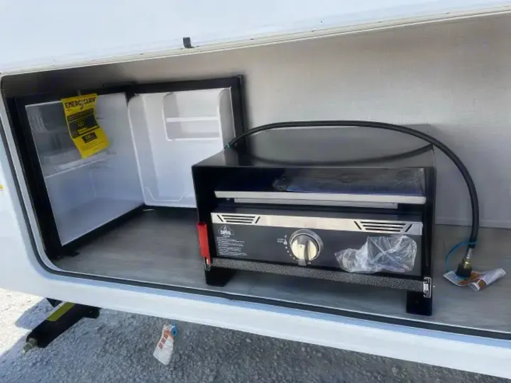 This RV rental offers an outdoor kitchen with a mini-fridge & a new portable griddle, perfect for convenient outdoor cooking.. Forest River Salem FSX 2026