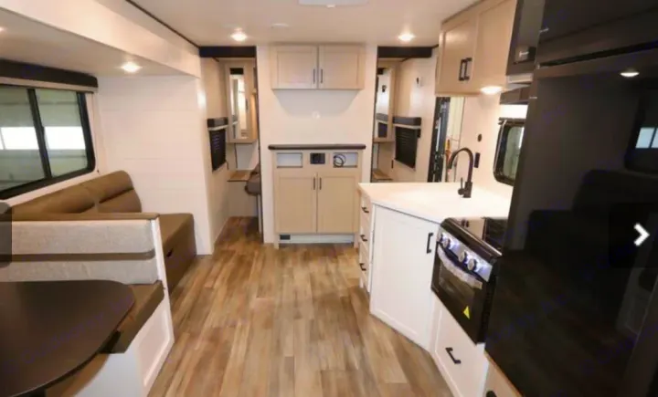 Spacious RV rental with open-plan kitchen, living area, and dinette. Modern interior for comfortable travel.. Highland Ridge RV Colt 2026