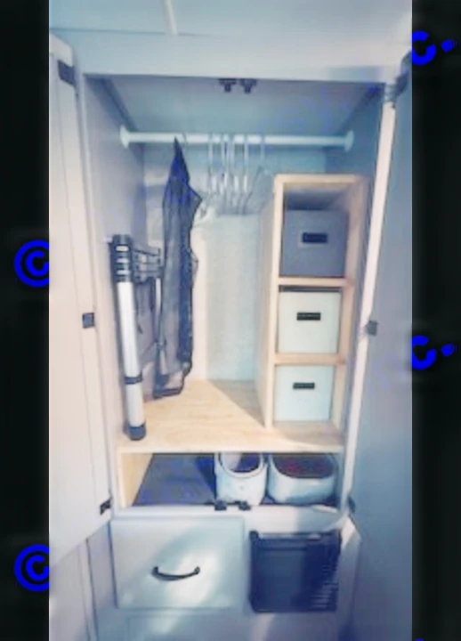 This RV rental closet offers smart storage: a hanging rod, wooden shelves with bins, and floor-level organizers maximize small space.. Thor Quantum LC 2022
