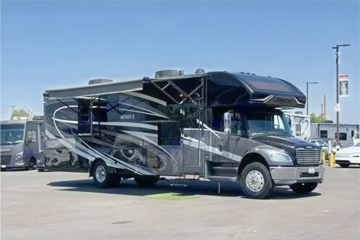 A large, dark grey Jayco Seneca RV motorhome with an extended awning, parked in a sunny lot. Ideal for rv rental.. Jayco Seneca 2020