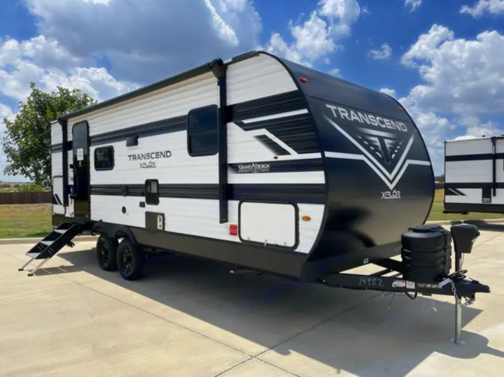 Grand Design Transcend XPLOR travel trailer, ideal for your next rv rental adventure, parked on concrete under a blue sky.. Grand Design Transcend Xplor 2026
