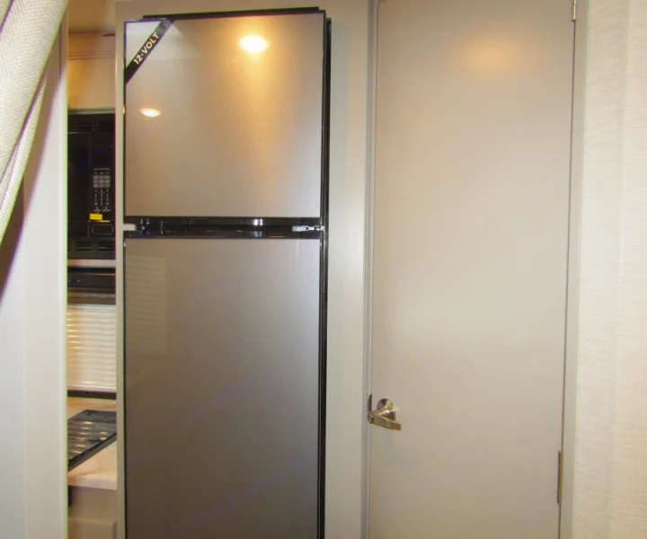 This RV rental features a compact 12-volt refrigerator and an interior door, providing convenience for your travels.. Thor Chateau 2025