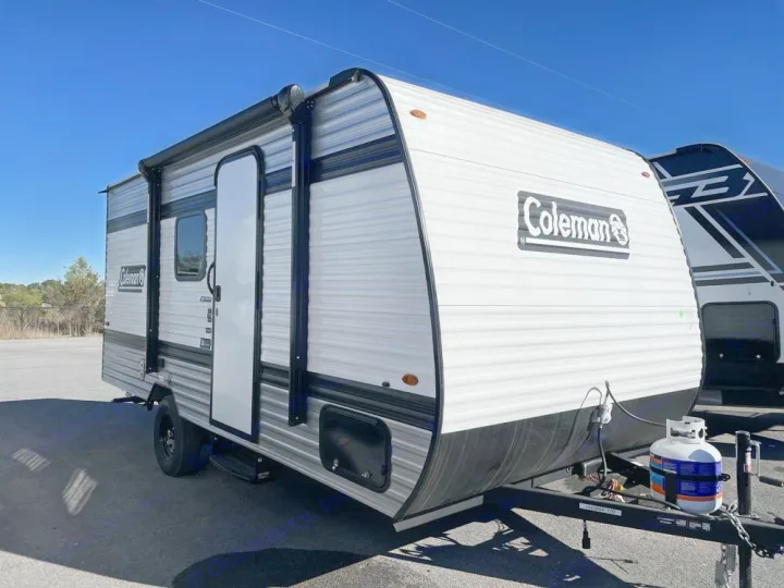This white and black Coleman travel trailer is ideal for an RV rental. Ready for camping adventures under a clear sky.. Coleman Coleman 17B 2026