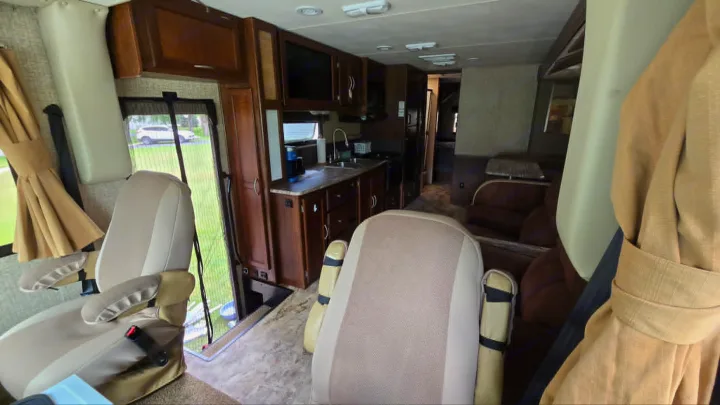 Spacious RV rental interior featuring a modern kitchen, comfortable seating, and a cozy living area. Ideal for road trips.. 1F65F5DY3E0A15748 Pursuit 31 BD 2015