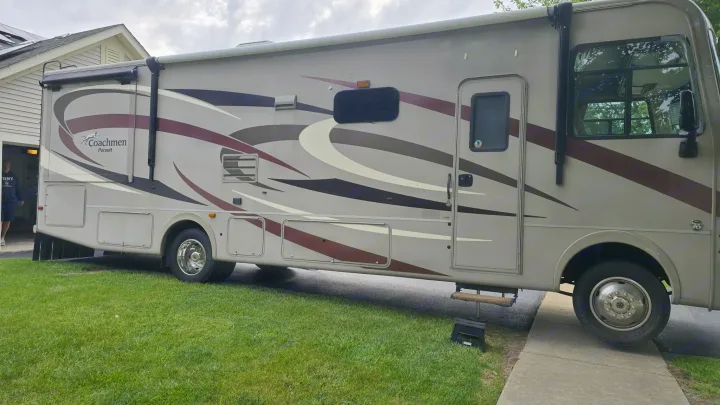 This Coachmen Pursuit RV rental, a beige and brown motorhome with graphic designs, is ready for a road trip adventure.. 1F65F5DY3E0A15748 Pursuit 31 BD 2015