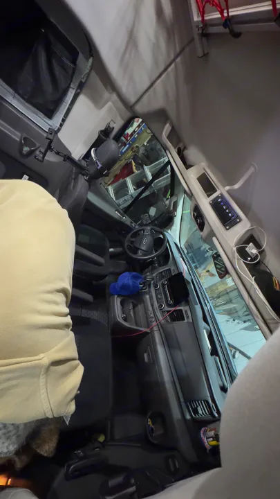 RV rental: Driver's cabin view with dashboard, steering wheel, custom controls, overhead storage, and a blue cap.. Ford Custom Transit 2020