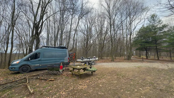 RV rental adventure: Camper van, boat, bikes & campfire in a serene wooded campsite.. Ford Custom Transit 2020