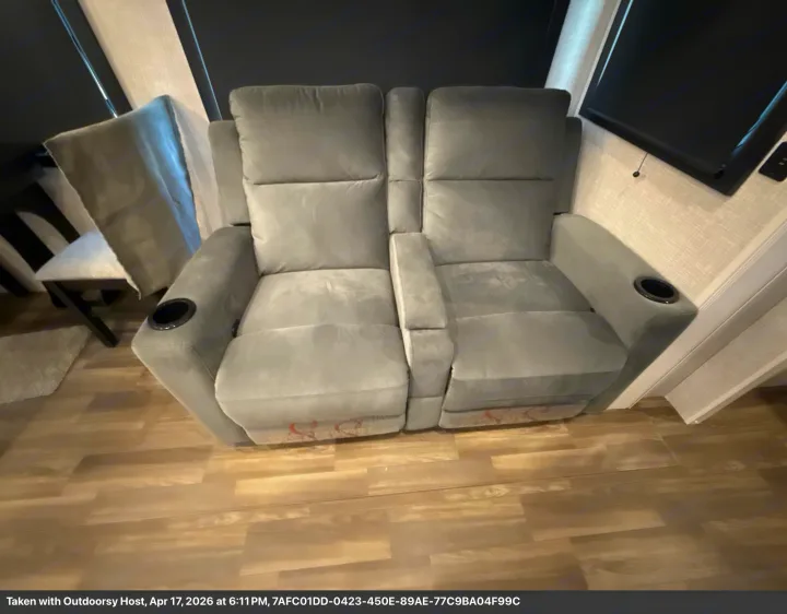 Relax in comfort! This RV rental features cozy gray reclining seats with built-in cup holders and a sleek wooden floor.. Jayco Eagle 2025