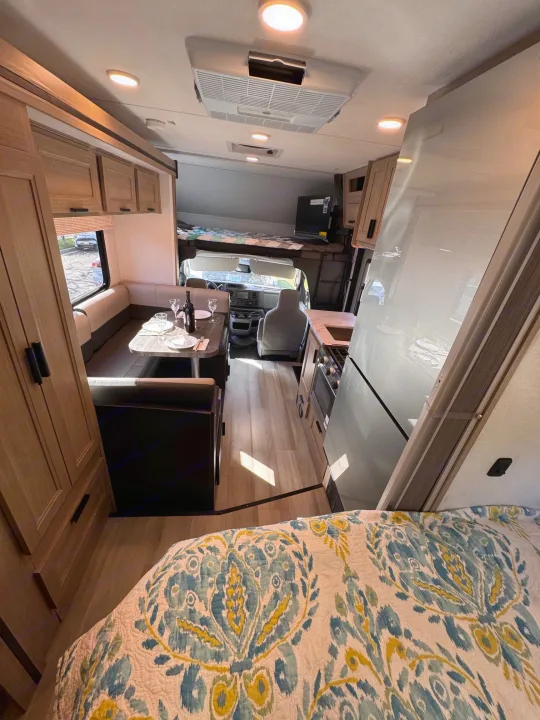 This RV rental offers a well-appointed interior, featuring a dinette, kitchen, and multiple sleeping areas, all with modern finishes.. Forest River Sunseeker LE 2025