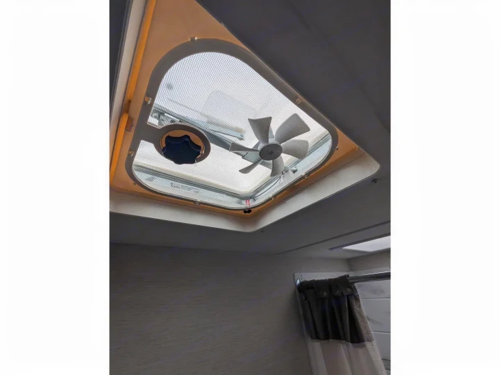 RV rental: Ceiling vent with fan and screen provides airflow in the bathroom, seen with a shower curtain below.. Thor Chateau 2025