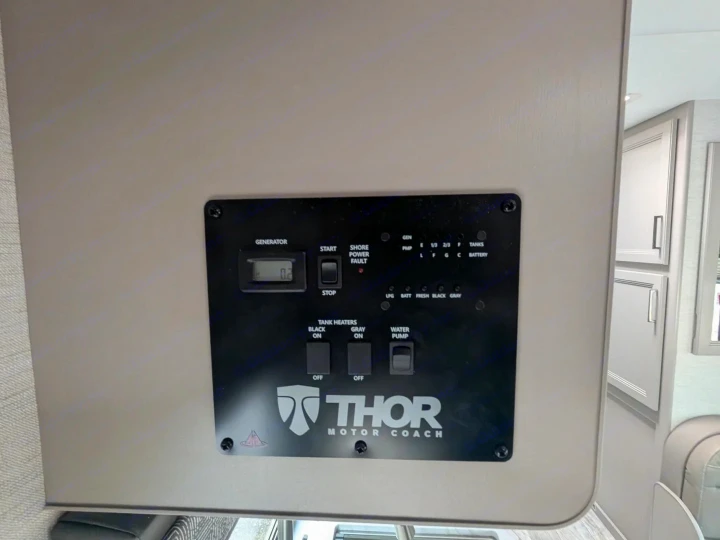 RV rental control panel showing generator, water pump, tank heaters, and tank/battery status for a Thor Motor Coach.. Thor Chateau 2025