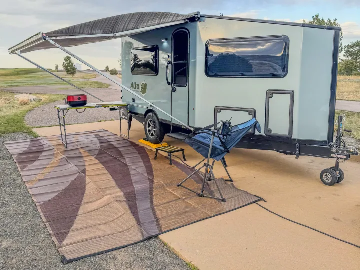 Alto travel trailer rv rental parked with an awning, outdoor rug, and grill, ready for camping. Ideal for outdoor adventures.. Safari Condo A2124 2025