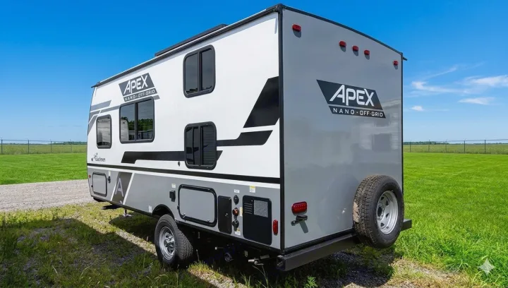 APEX Nano off-grid travel trailer RV rental, parked in a sunny field. Ready for your next adventure!. Coachmen Apex Nano 2023