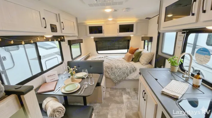 Explore this stylish RV rental interior! Features include a well-appointed kitchen, dining area, and cozy bedroom space.. Coachmen Apex Nano 2023