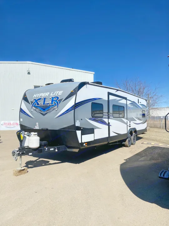 Explore this sleek gray & white Hyper Lite XLR travel trailer, ideal for your next RV rental adventure.. Forest River XLR HyperLite Toy Hauler 2017
